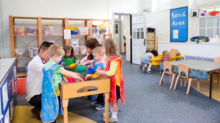  Children and teachers in preschool classroom.