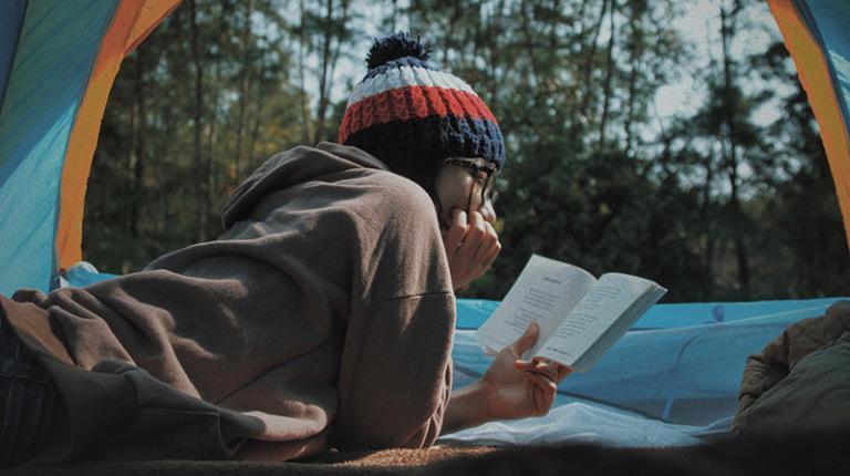  Girl camping and reading a book