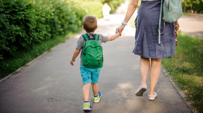  Mother walking child to preschool.