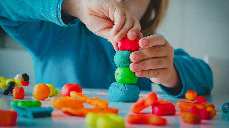  Preschool child playing with playdough