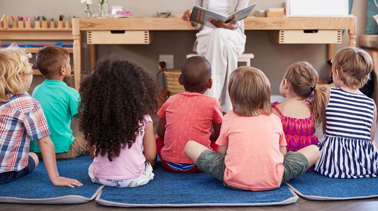 Children being read a story at preschool.